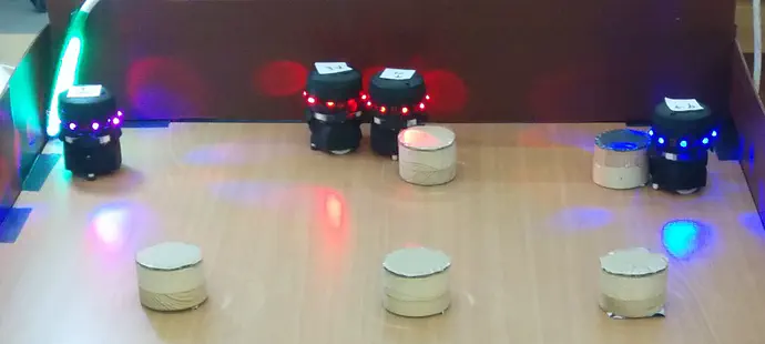 Krembot robots foraging in our lab, using reinforcement learning.